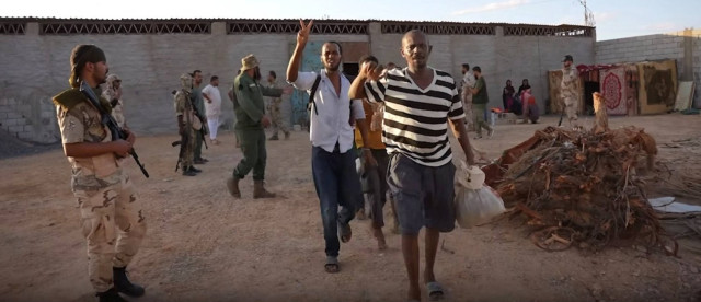 Victims gesture as authorities dismantle a human trafficking network, according to Libyan authorities, in what they say is Libya, in this still image from a handout video released on August 31, 2024. Attorney General Office - State Of Libya