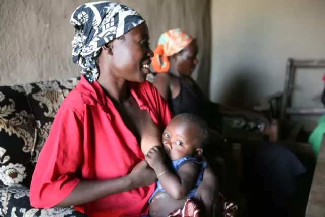 A woman breastfeeding her baby