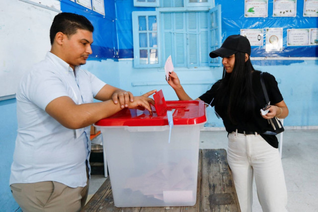 voter casts her ballot at a polling station during the presidential election in Tunis, Tunisia October 6, 2024