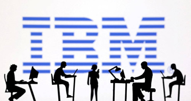 Figurines with computers and smartphones are seen in front of IBM logo in this illustration taken