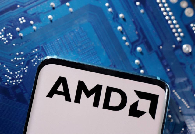 A smartphone with a displayed AMD logo is placed on a computer motherboard in this illustration taken March 6, 2023