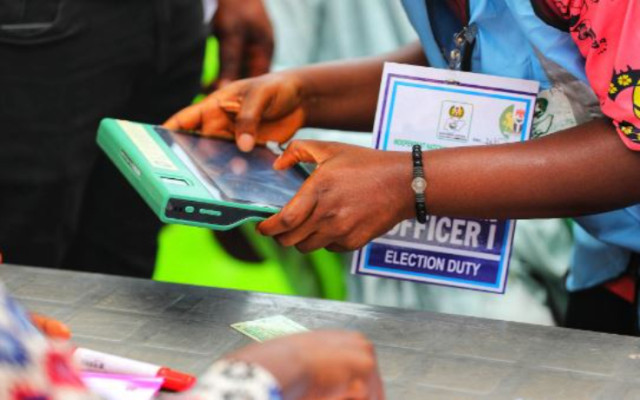 INEC official operating a BVA machine