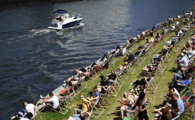 People enjoy the sunny weather on bank of Spree river during the Catholic feast days of Pentecost, in Berlin, Germany June 5, 2022