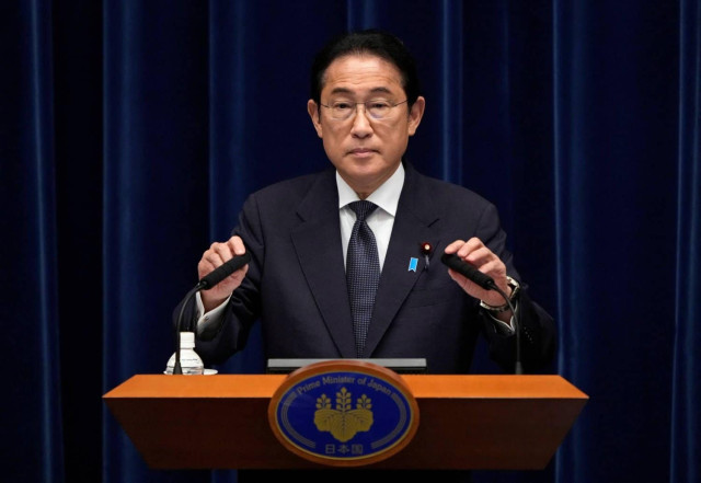Picture of Japan's Prime Minister Fumio Kishida adjusts microphones at the start of a press conference at the prime minister's office in Tokyo, Japan, June 21, 2024.
