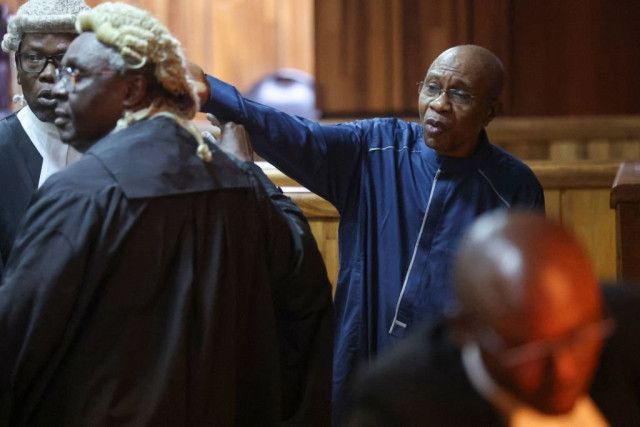 Suspended governor of Nigeria’s Central Bank Godwin Emefiele (R) appears at the Federal Capital Territory High Court over allegations of breach of procurement act and financial fraud in Abuja, Nigeria, on August 17, 2023.