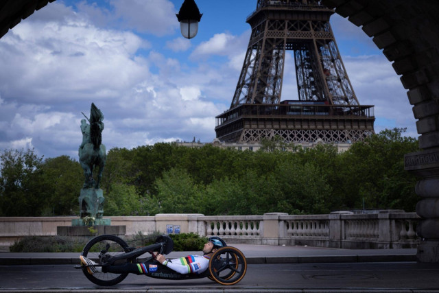 France's paralympian cyclist Florian Jouanny poses at the Bir-Hakeim Bridge ahead of the Paris Olympics and Paralympics.