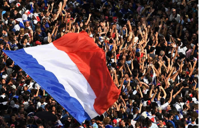 Supporters wave French national flags