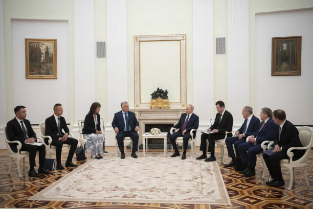 Russian President Vladimir Putin (C-R) and Hungarian Prime Minister Viktor Orban (C-L) during their meeting as Russian Foreign Minister Sergei Lavrov (3-R), Hungarian Minister of Foreign Affairs and Trade Peter Szijjarto (2-L) and Orban's chief national s