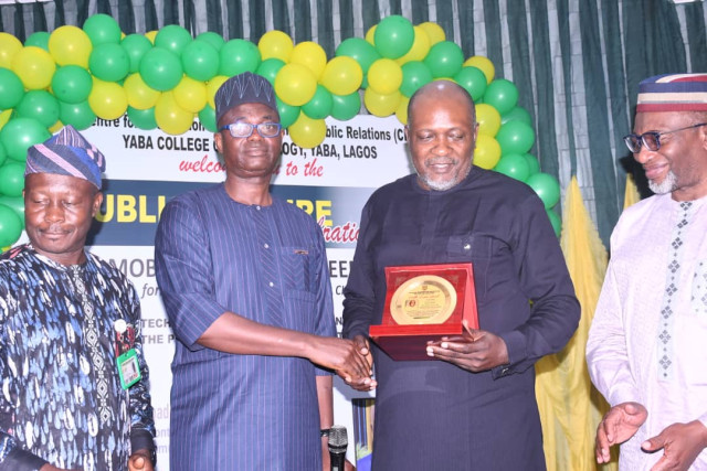 L-R: The Chairman of Lecture and Rector, Federal Polytechnic Ilaro, Dr. Mukail Akinde, presenting the Plaque Award of a well delivered lecture to the Guest Speaker's representative, Mr. Dotun Oladipo in the admiration of the Rector, Yaba College of Techno