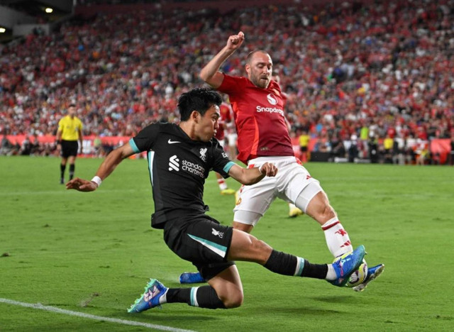 Liverpool's Japanese midfielder #03 Wataru Endo vies for the ball during the pre-season club friendly football match between Manchester United and Liverpool at Williams-Brice Stadium in Columbia, South Carolina, August 3, 2024