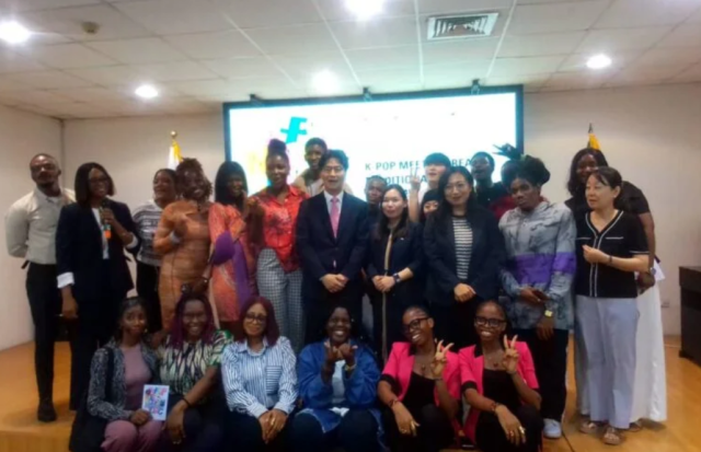 Director of the Korean Cultural Centre in Nigeria, Jeon Ju Ho, ,  in a group photograph with team members.
