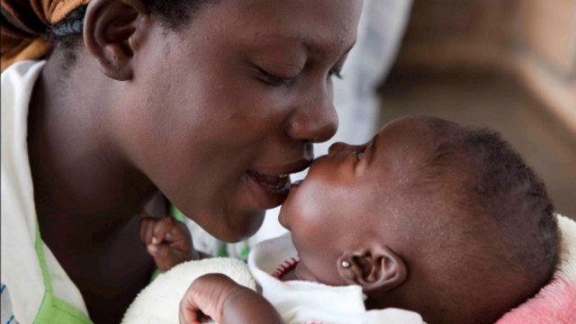 A mother  playing with her baby