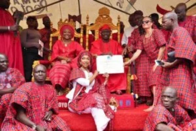 Minister of Art, Culture, Tourism, and the Creative Economy, Hannatu Musa Musawa, presenting the UNESCO World Heritage Certificate of Inscription for the Sango Festival to His Imperial Majesty, Oba Abimbola Akeem Owoade, the Alaafin of Oyo, during the gra
