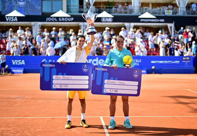 Tennis - Nordea Open - Bastad, Sweden - July 21, 2024 Portugal's Nuno Borges poses with the trophy after winning his men's singles final alongside Spain's Rafael Nadal