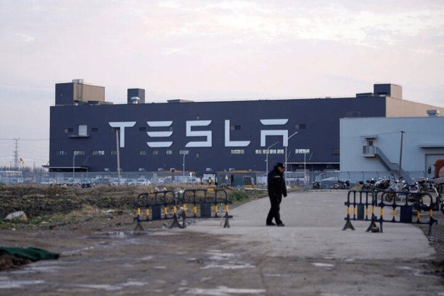 A Tesla sign is seen on the Shanghai Gigafactory of the US electric car maker before a delivery ceremony in Shanghai, China January 7, 2020