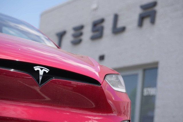 A Model X sports-utility vehicle sits outside a Tesla store in Littleton, Colo., on June 18, 2023.