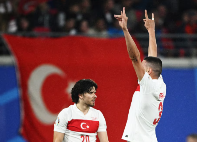 Merih Demiral celebrates scoring their second goal with a 'wolf' salute