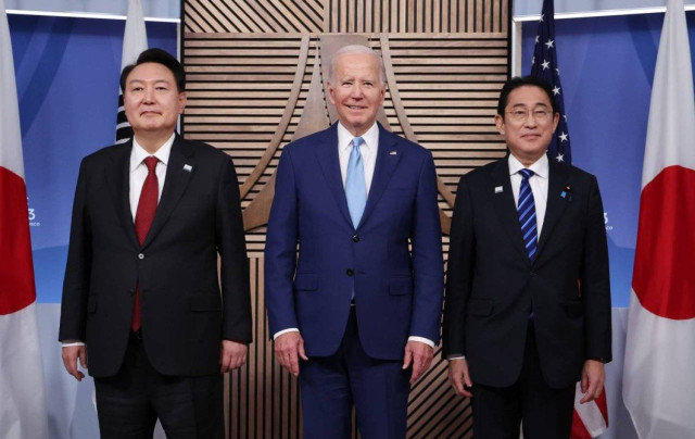 US President Joe Biden, South Korea's President Yoon Suk Yeol and Japanese Prime Minister Fumio Kishida stand together for a trilateral meeting at the Asia-Pacific Economic Cooperation (APEC) summit in San Francisco, California, US, November 16, 2023