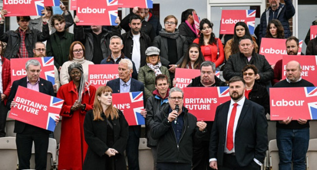 Britain’s main opposition Labour Party leader Keir Starmer (C), flanked by New Labour Party MP for Blackpool South, Chris Webb (R) and Britain’s main opposition Labour Party deputy leader and Shadow Levelling Up, Housing and Communities Secretary Angela R