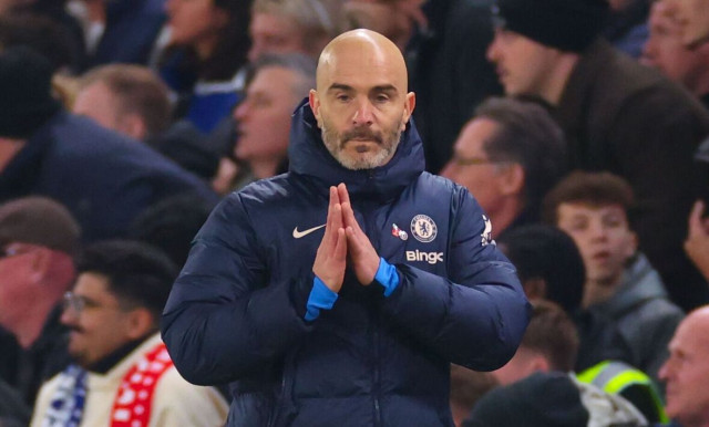 Chelsea assistant coach Enzo Maresca standing on the sidelines, making a hand gesture during a football match.