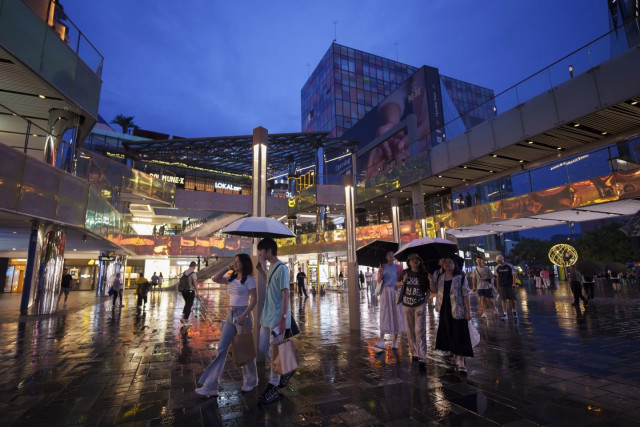 People shop at Taikoo Li Sanlitun shopping center in Beijing, China, on July 2, 2024. On Tuesday, July 16, 2024