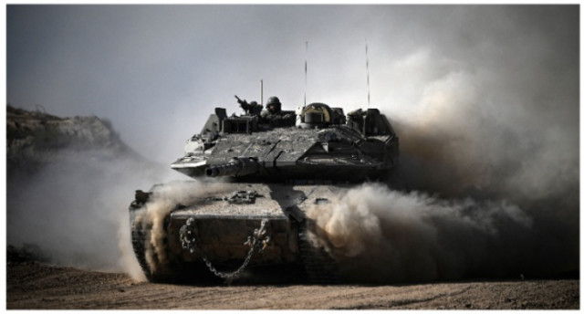 An Israeli army battle tank moves in an area along the border with the Gaza Strip and southern Israel