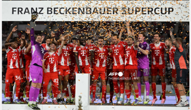 Munich's team celebrates on the podium with the trophy after the Franz-Beckenbauer Supercup football match between VfB Stuttgart and FC Bayern Munich in Stuttgart, southern Germany on August 16, 2025. Originally established in 1987 by the German Football 