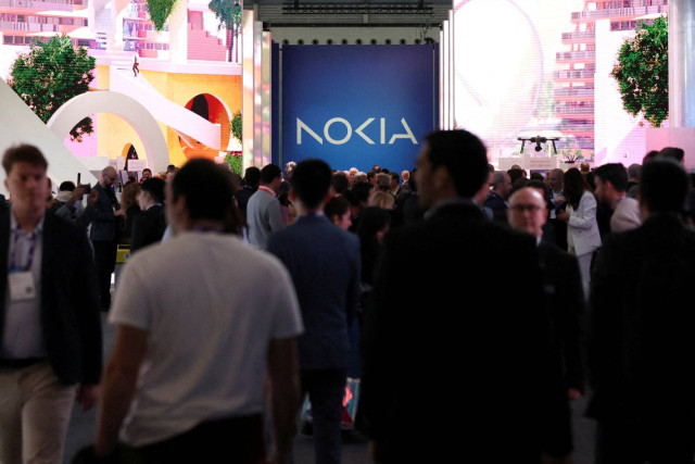 People walk next to Nokia stand as they attend the Mobile World Congress (MWC) in Barcelona, Spain February 27, 2024.