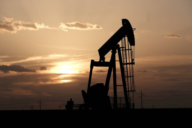 Oil pump jacks work at sunset near Midland, Texas, US, August 21, 2019