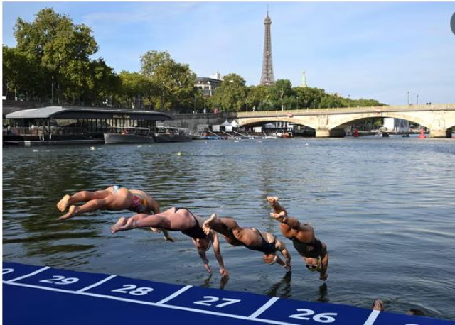 Athletes dive into the River Seine during the swim familiarisation event before triathlon test races in Paris last August