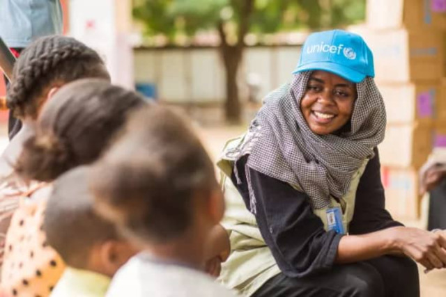 Photo of UNICEF representative and pupils