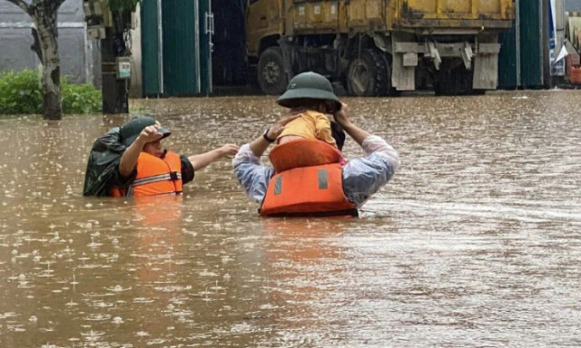 Photo of Vietnam Flood Rescue Operatives in the midst of the flood